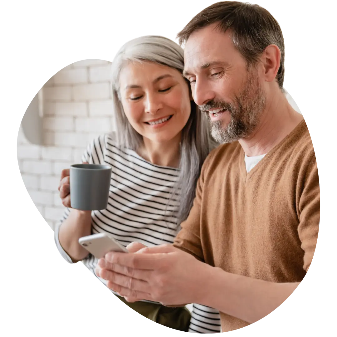 Mature couple relaxing together with smartphone